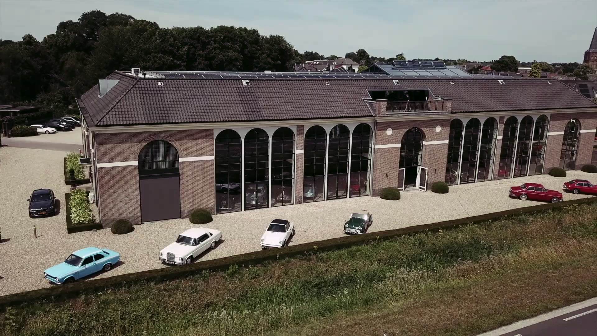 The long arched brick and glass facade of the showroom.